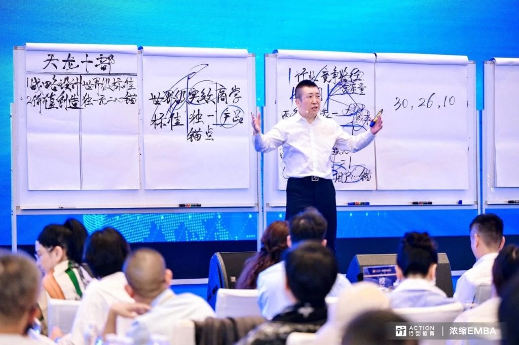 Business trainer explaining strategic management concepts on whiteboards during a professional development seminar.