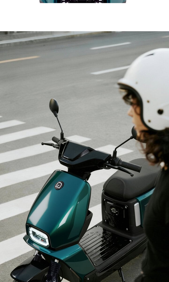 Modern electric scooter parked at a city crosswalk, ready for urban commuting. Features a sleek design, digital display, and eco-friendly technology ideal for city transportation.